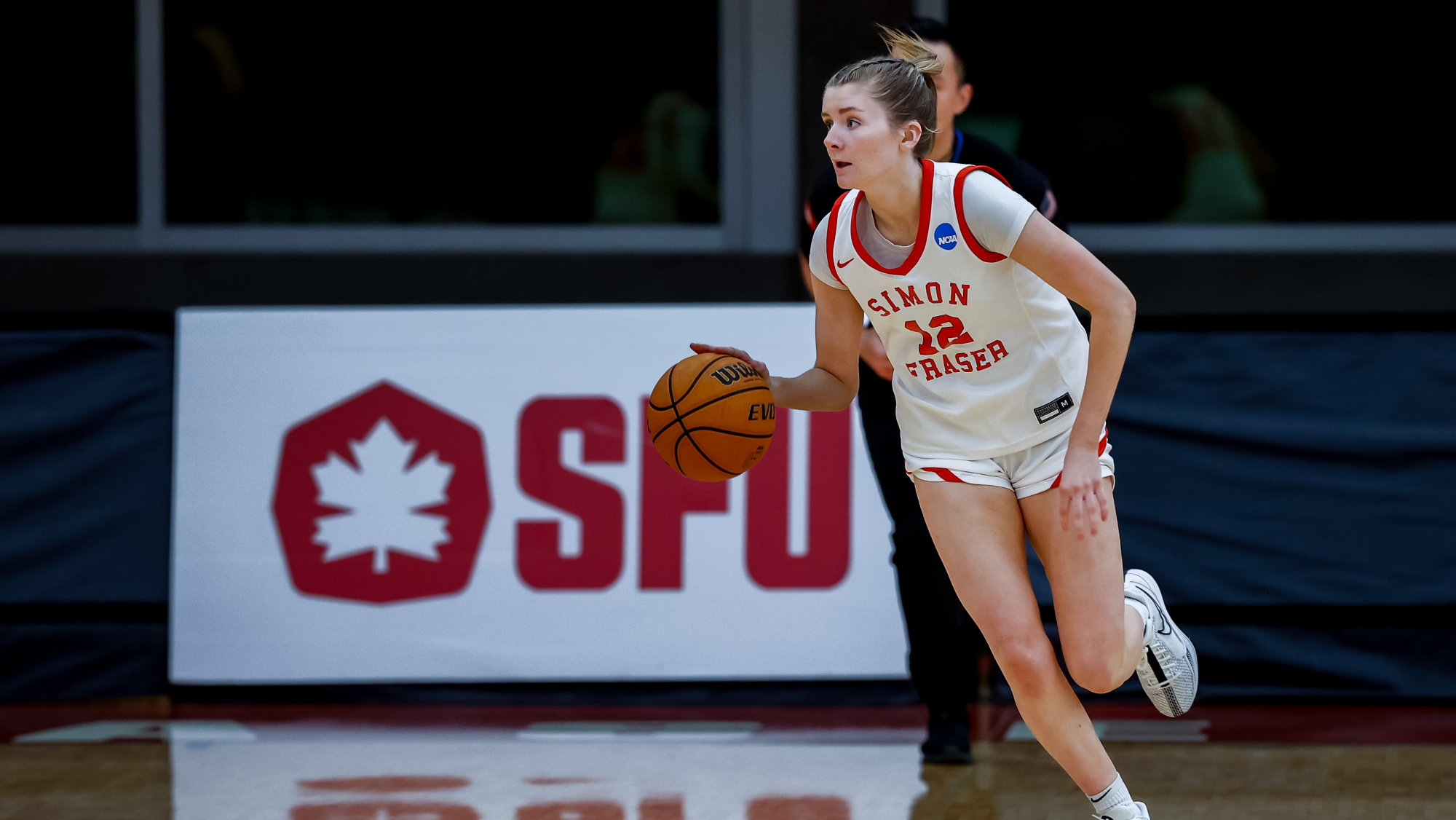 Rachel Loukes dribbles the ball down the court