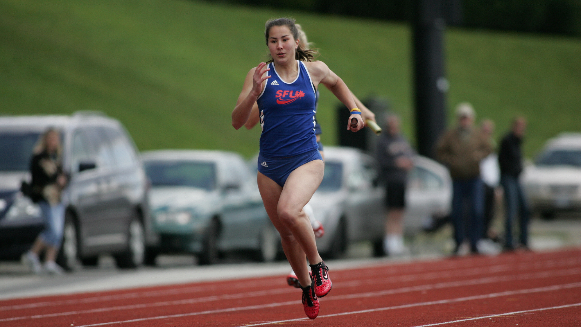 Jane Channell competes in a women's 4x100 relay in 2007. Photo: John Devins/Simon Fraser University