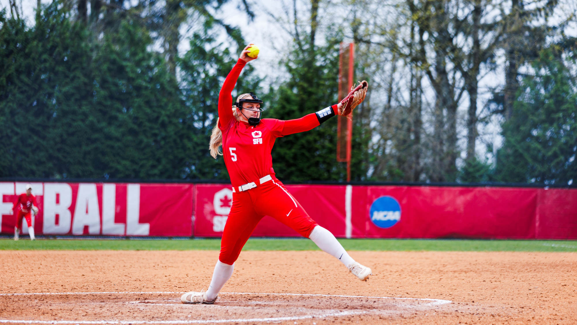 Monica Bourque winds up to pitch during a game