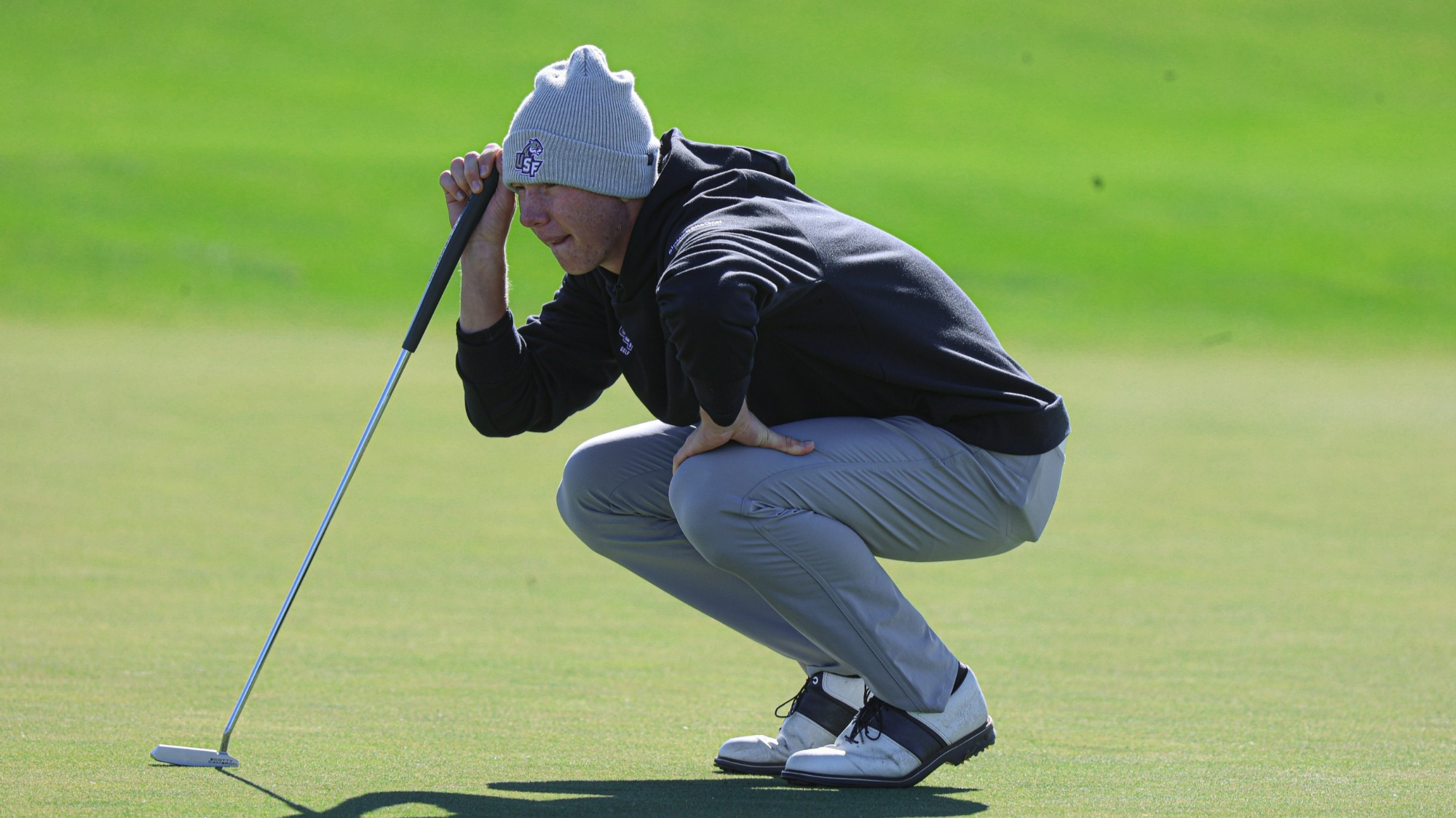 Charlie Hanson lines up the putt