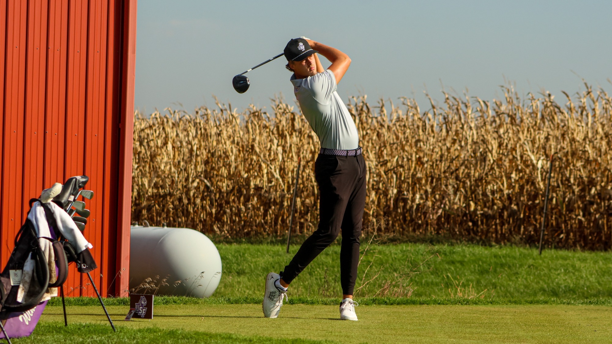 Men's golfer watching shot after hitting the ball