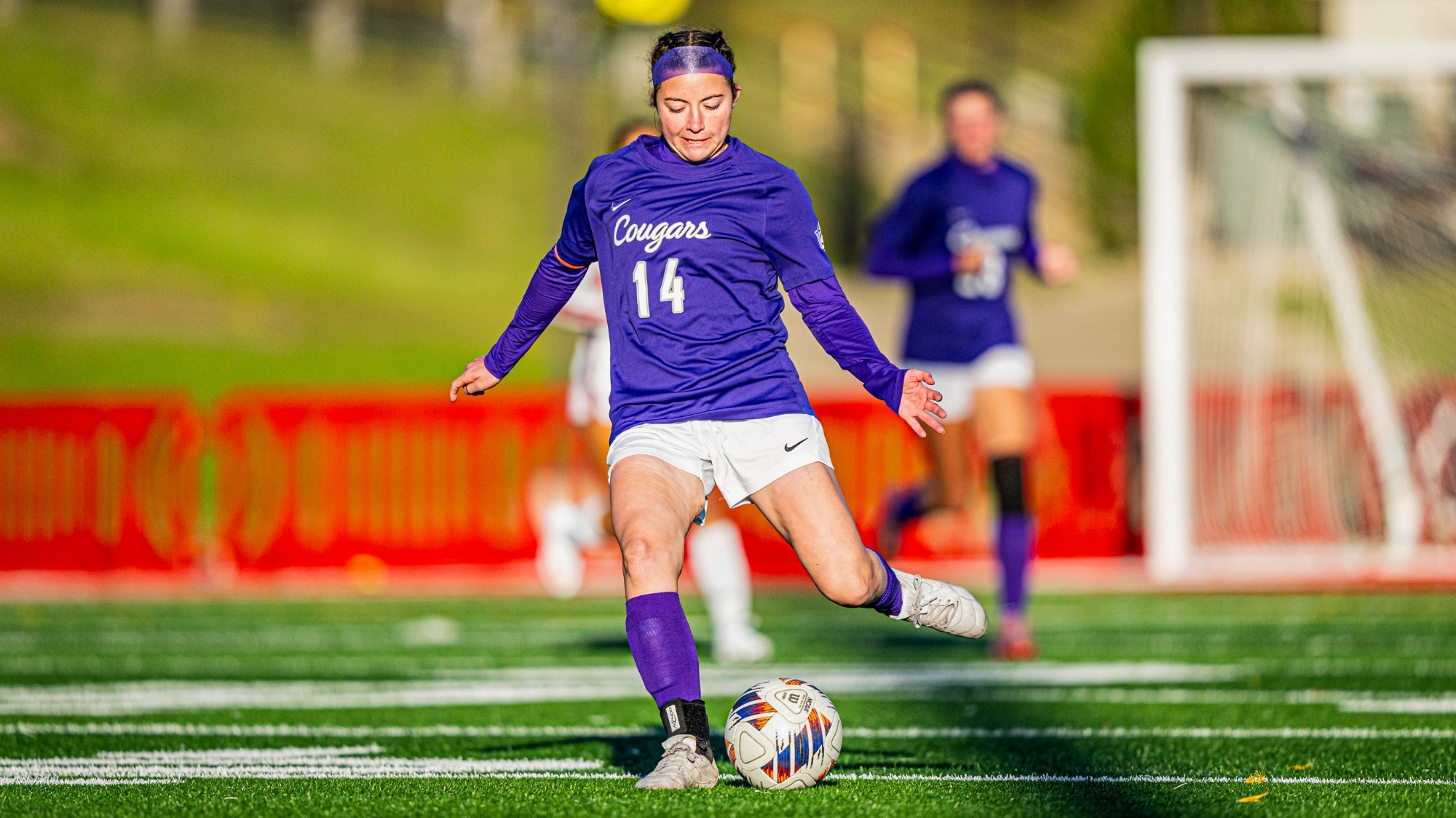 Mara Nelson kicking a ball against Minot State