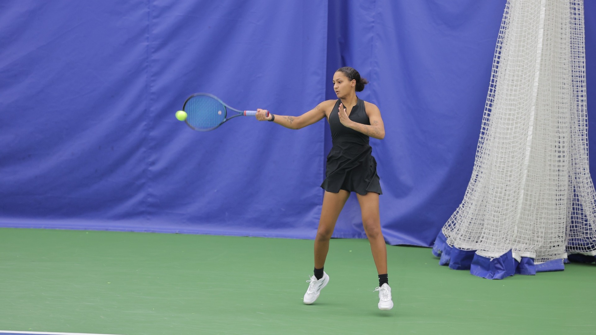 Sofiya Janos serves the ball