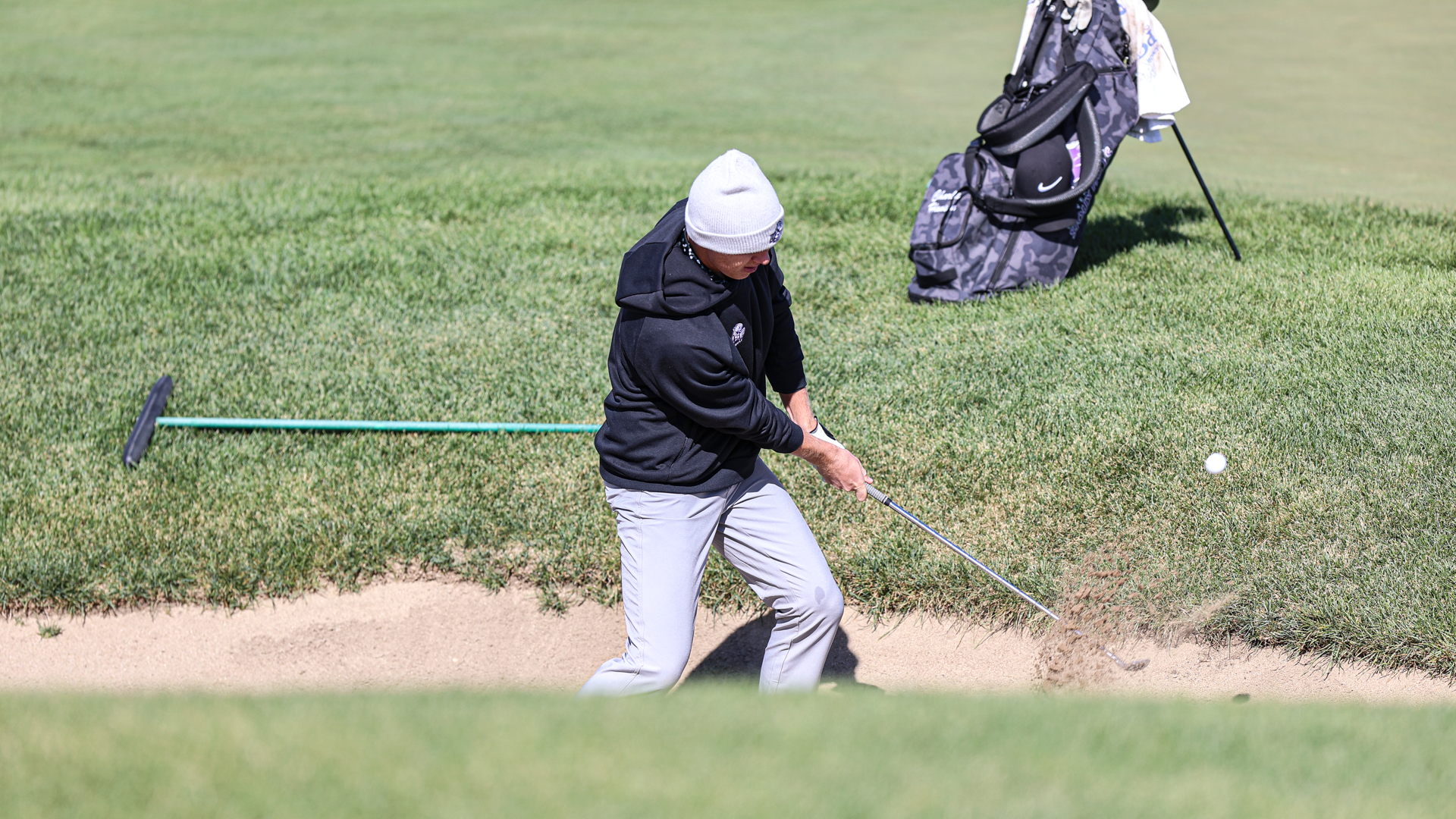 Charlie Hanson hits out of the bunker