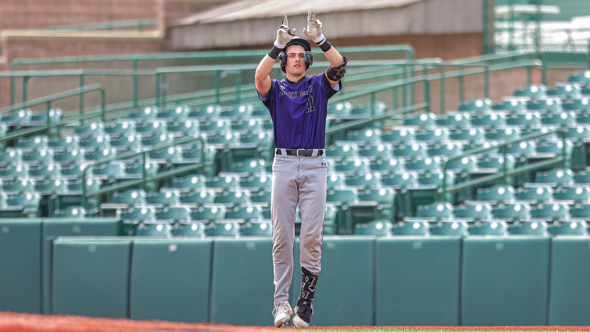 Drew Miller raises his hands in celebration with his teammates