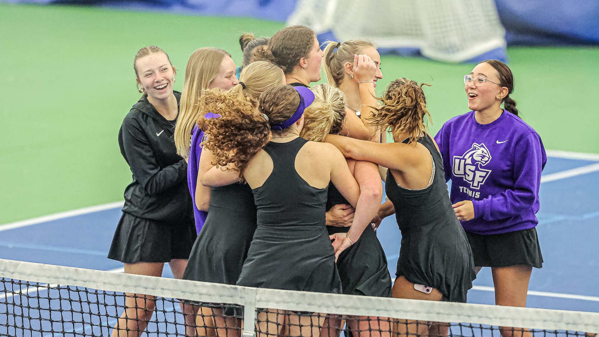 USF Women's Tennis Celebrates after taking doubles point against Minnesota State