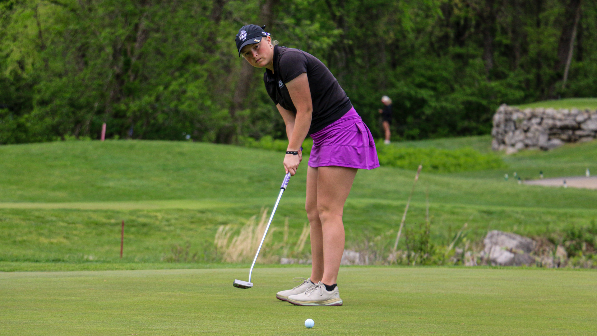 Tanna Phares watches as her putt rolss
