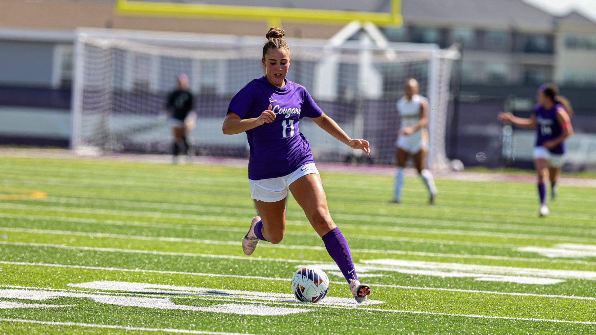 USF Soccer student-athlete Addison Van Zee dribbles the ball upfield