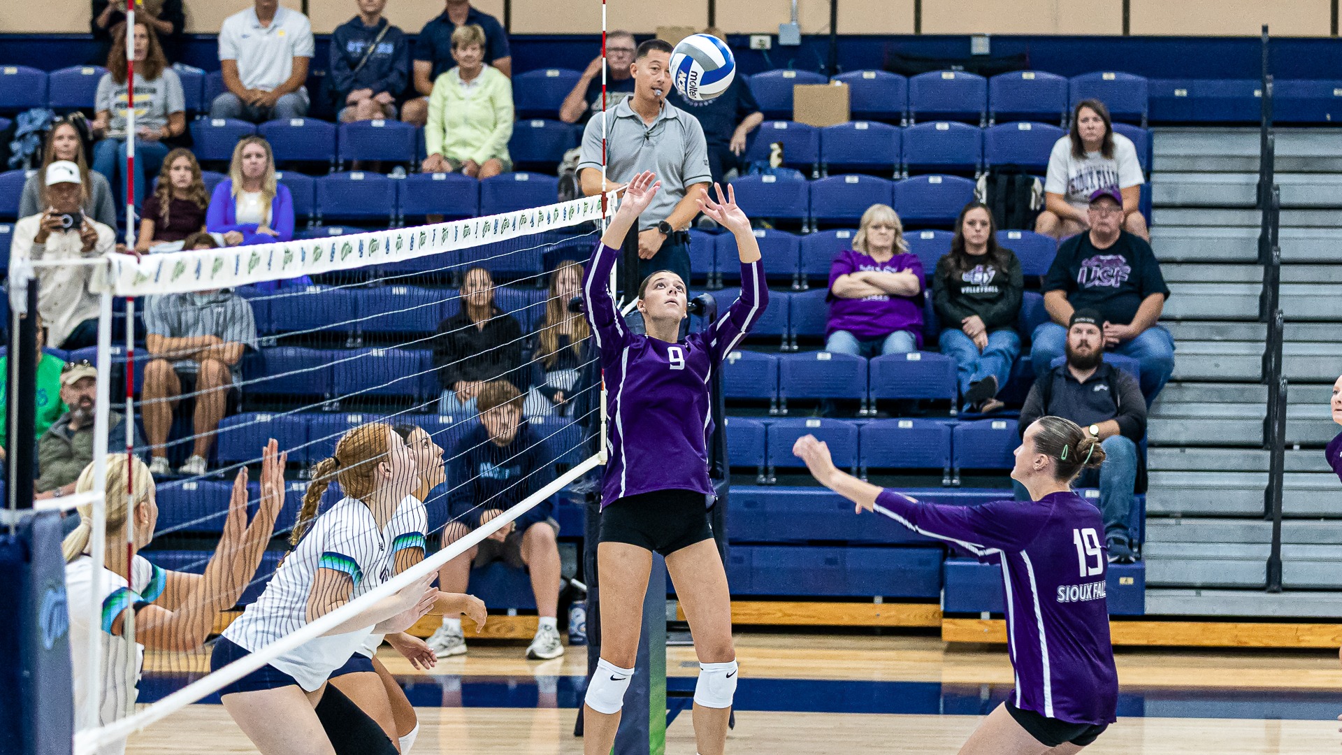 Hollie Peterson sets the ball for Ella Walker against Cal State Monterey Bay