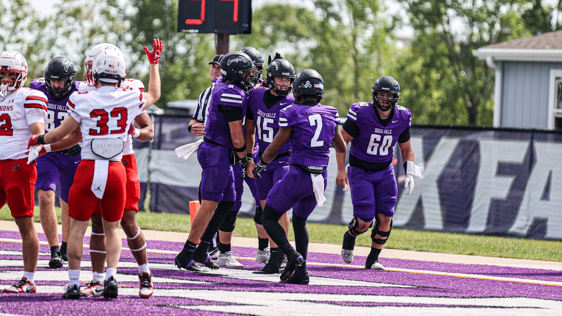 Bennett Brueck and the offense celebrate following a rushing touchdown against MSU Moorhead