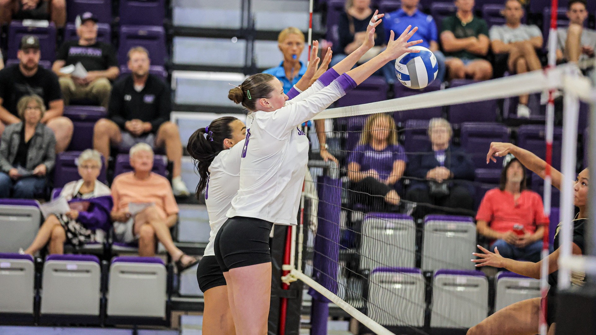 Ella Walker and Tatum Godinez make a block against Emporia State