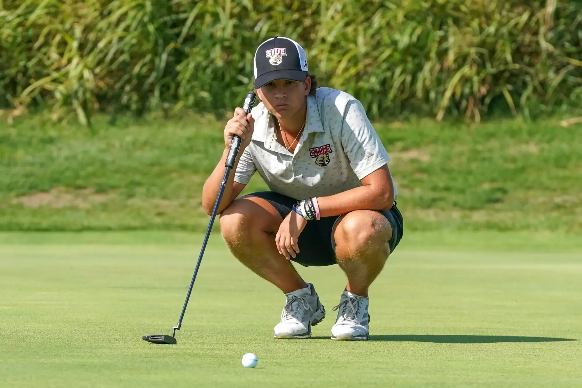 Tomas Rascon measures a putt at the Dolenc Invitational