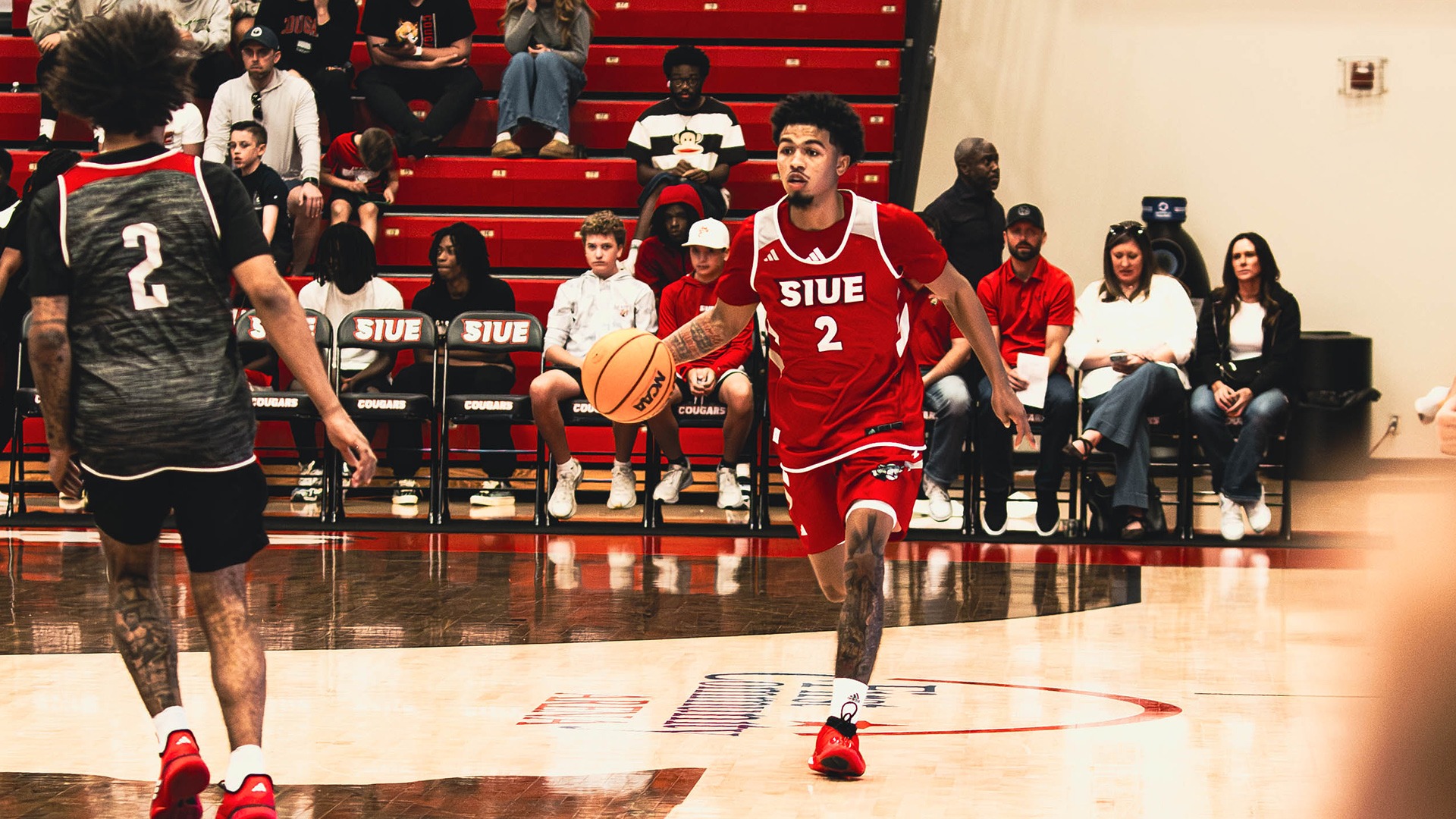 Gianni Cobb dribbles up the floor in the exhibition against Arkansas State