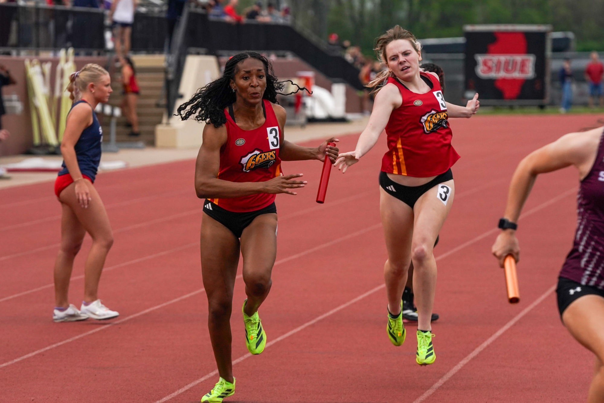 SIUE T&F Cougar Classic 2026 women's 4x400m relay, hand off between Callie Field and Jaiden Parker at Ralph Korte Stadium