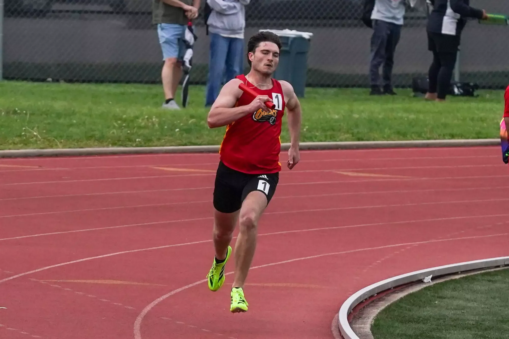 Simon McClaine running the men's 4x100 at the 2026 Cougar Classic, wearing 66ers uniform