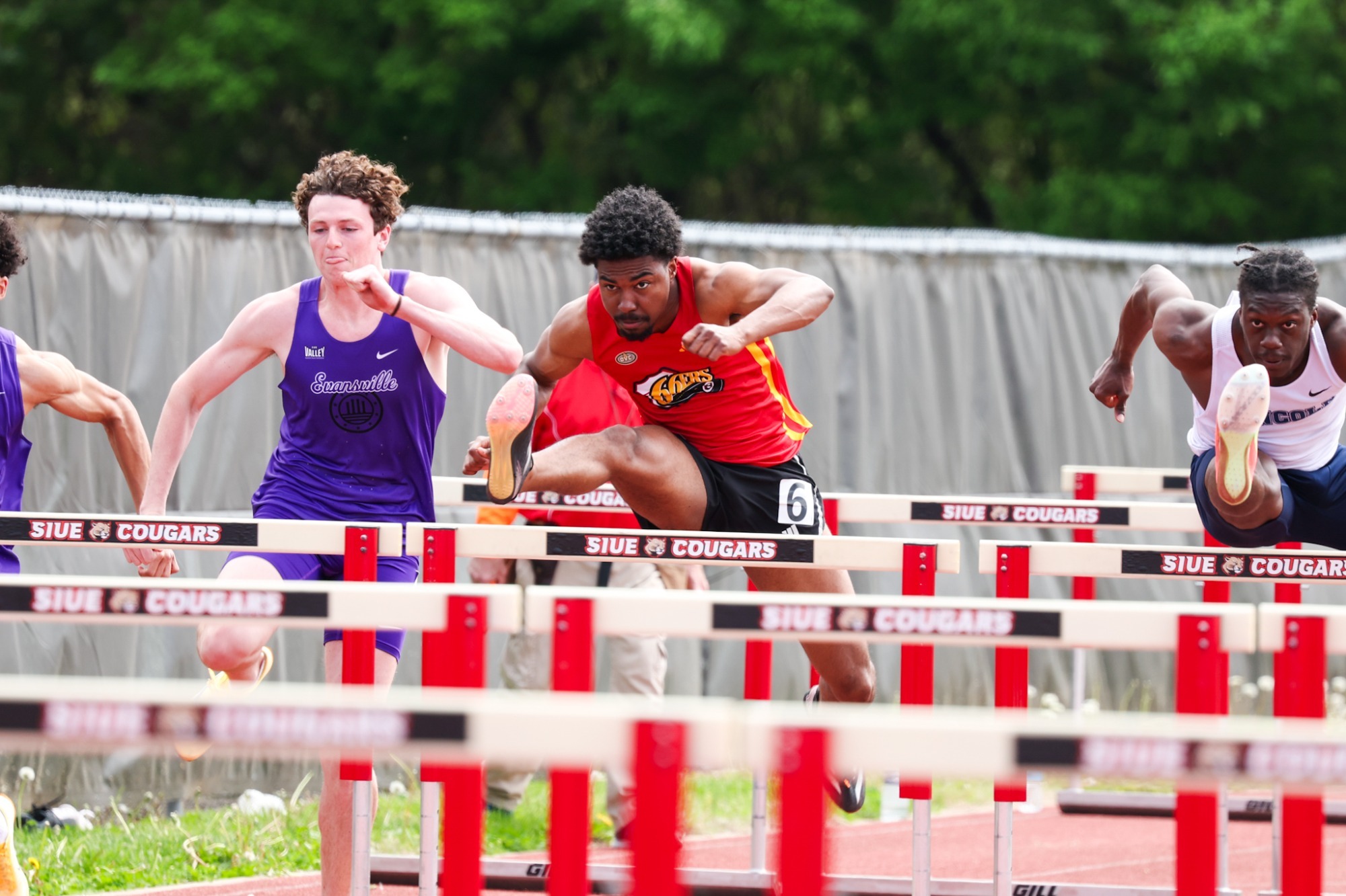 Tyler Bell running men's 110m hurdles at 2026 Cougar Classic wearing 66ers uniform