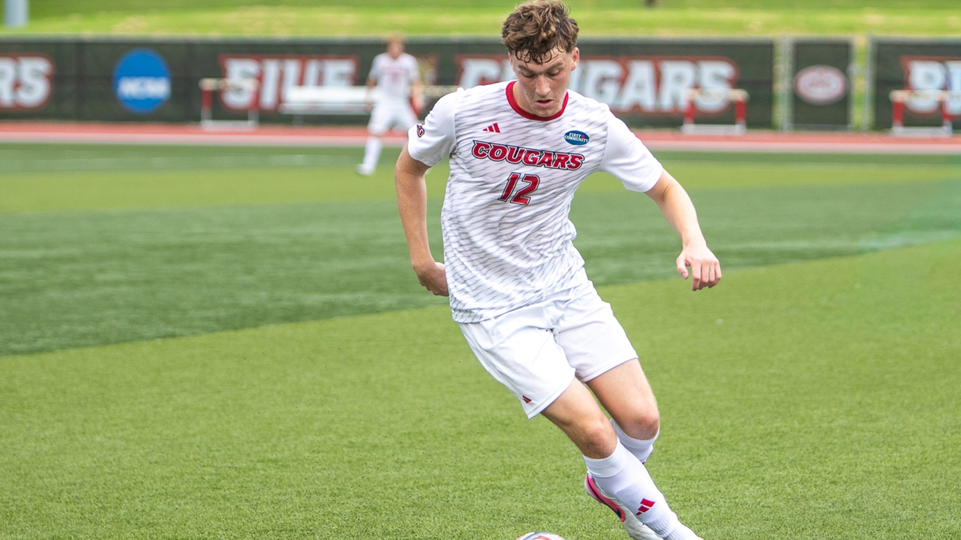 Robbie Spain carries the ball in an exhibition game against Iowa Western