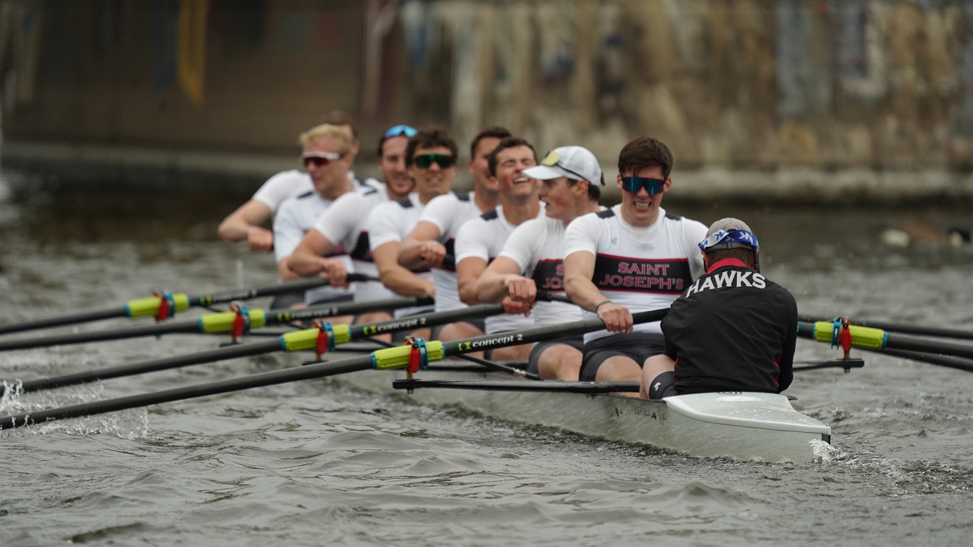 Men's rowing 8 moves down the river.