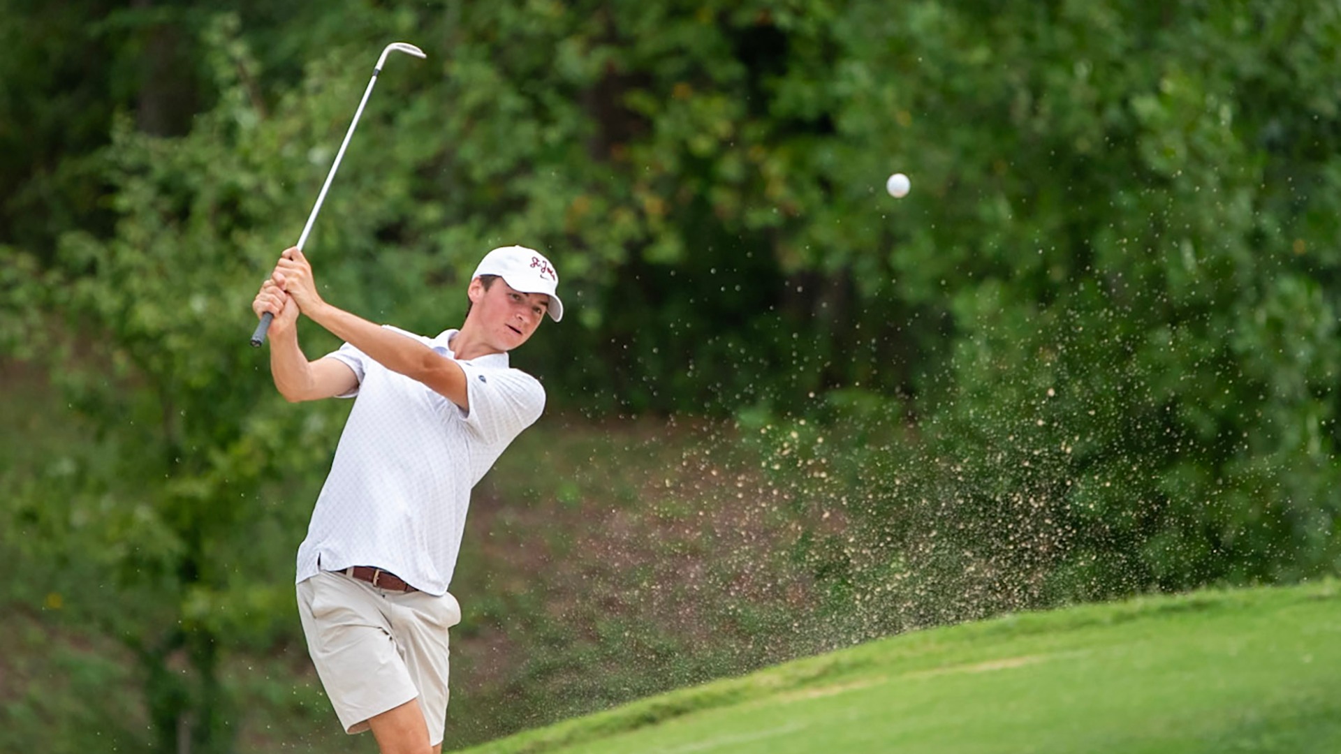 St. Joe's student-athlete stares at his wedge shot.