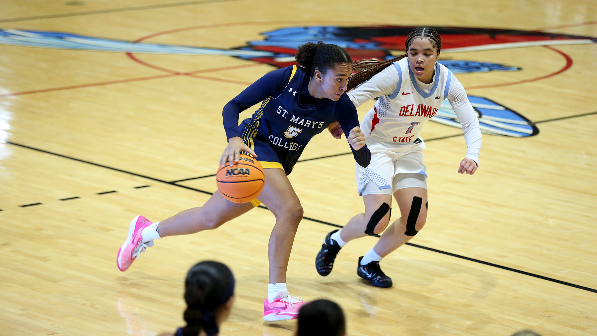 Sidney Shaw drives past Delaware State defender on Nov. 22, 2025
