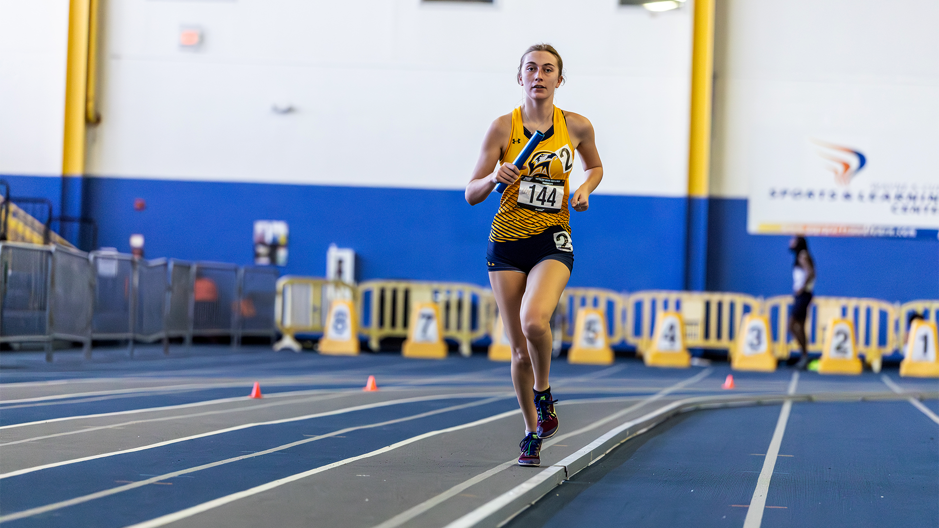 Ellie Geiger on the track with a baton at United East Indoor Championships on February 28, 2025