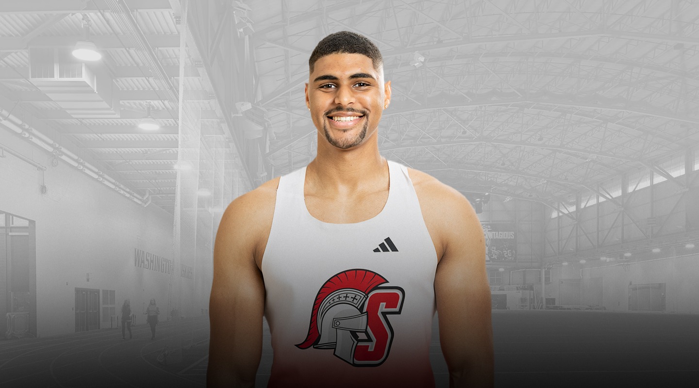 A photo of Samuel Gray in front of the Dempsey Indoor Center