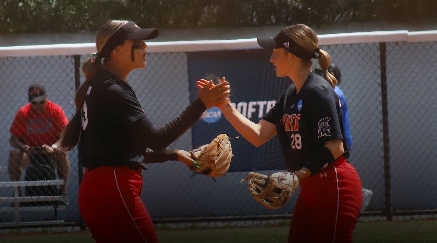 Shelby Lawson and Ava Heston celebrating together after a defensive play