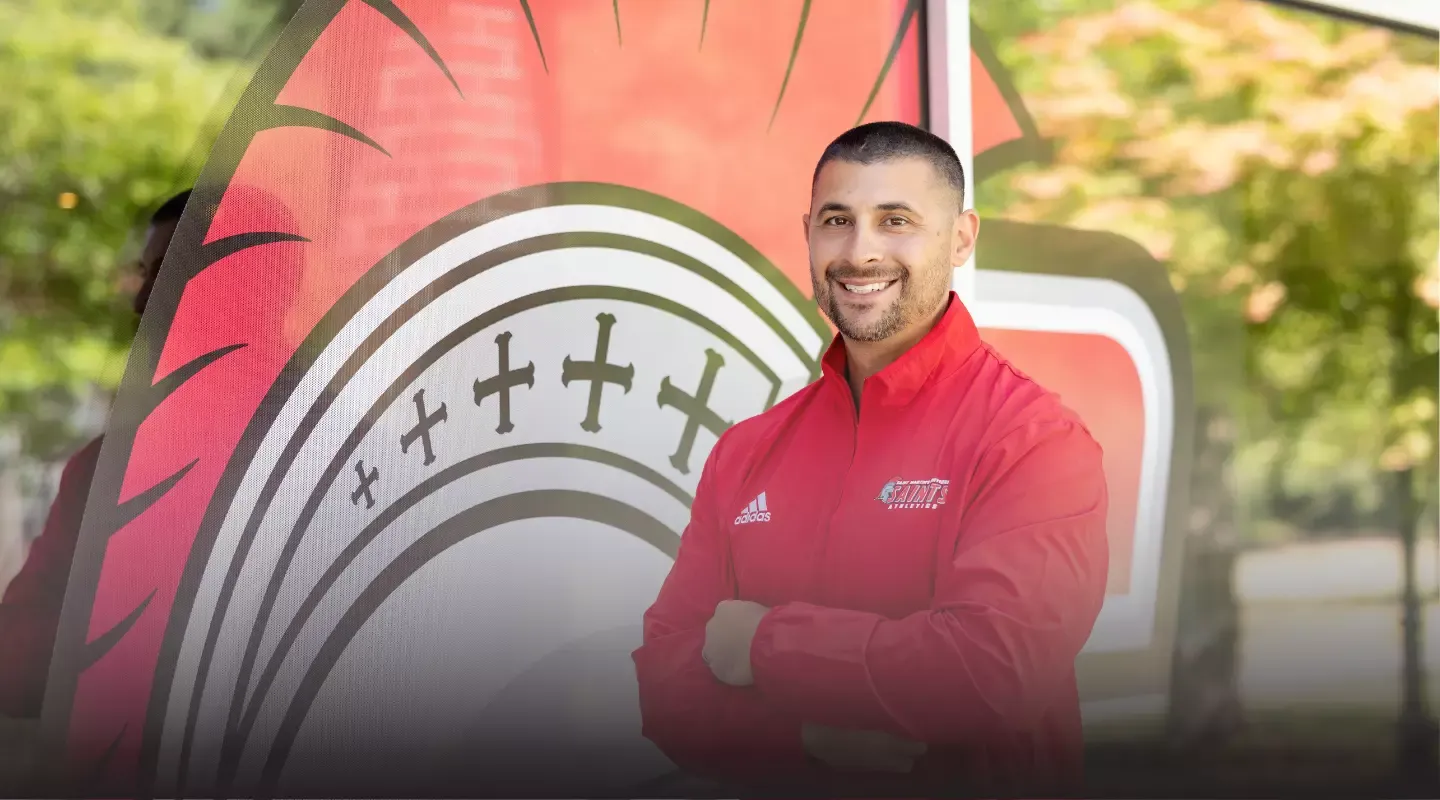 Jacob Garsez in front of window with decal of Saints helmet