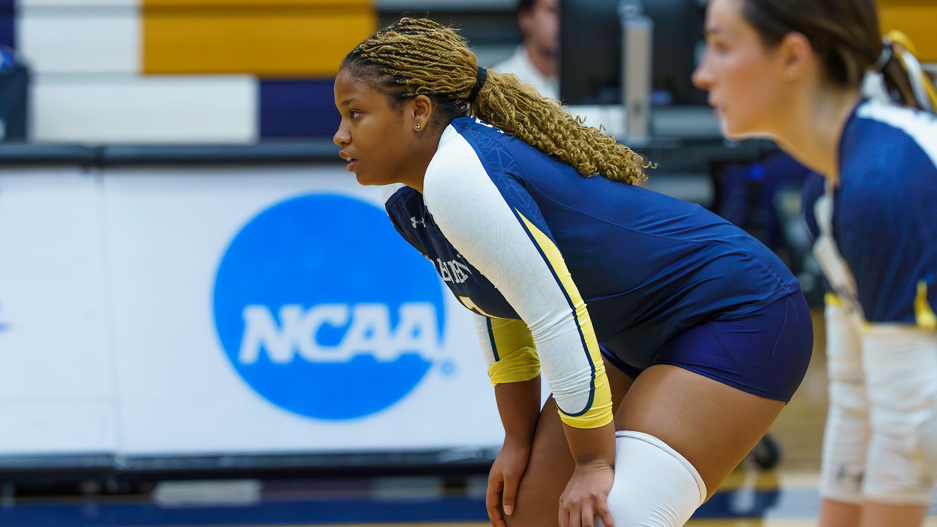 Ananda Burgos with her hands on her knees in between plays