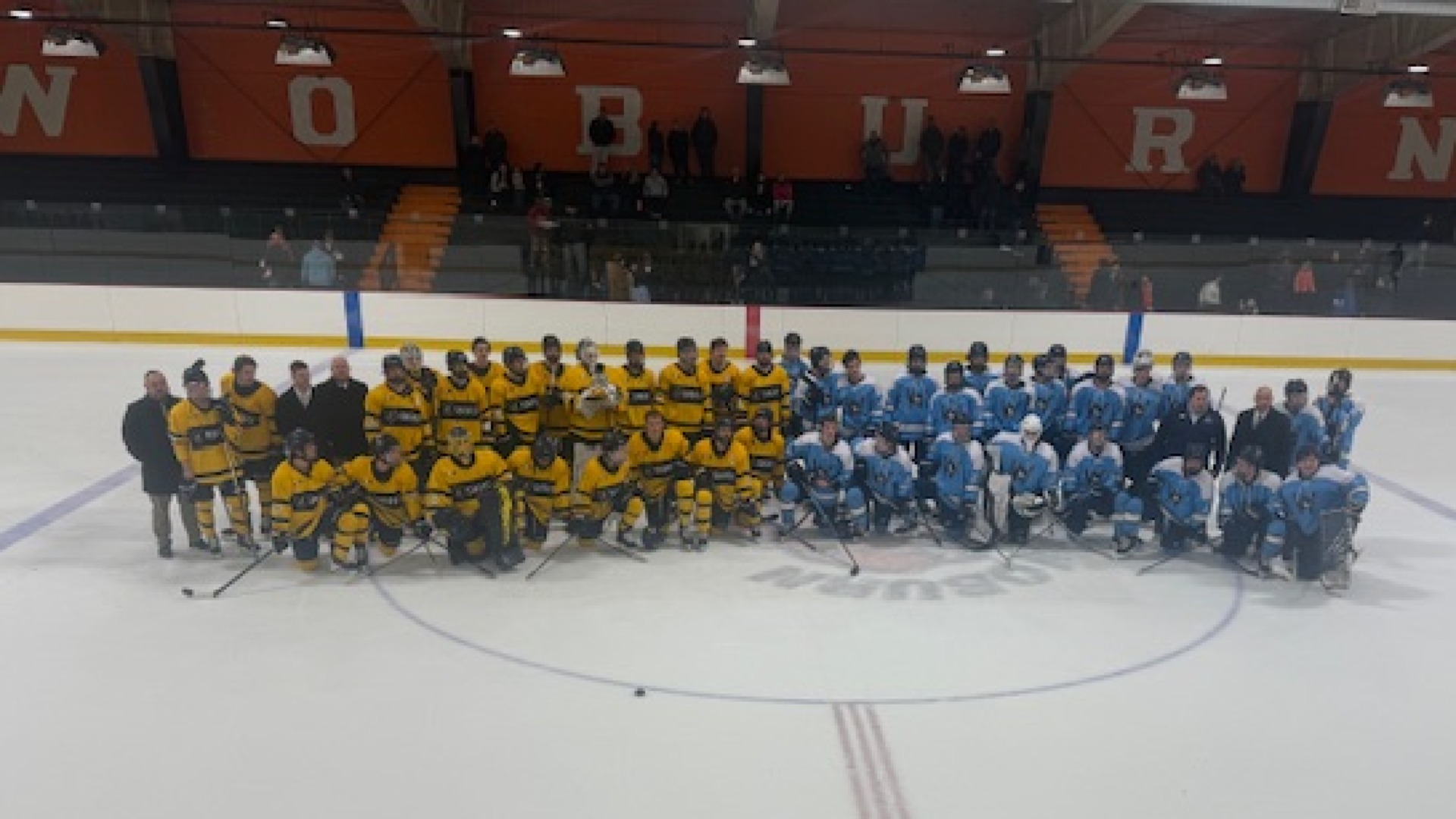 Photo of SNHU and Westfield State on the ice after Hockey Fights Hunger Game