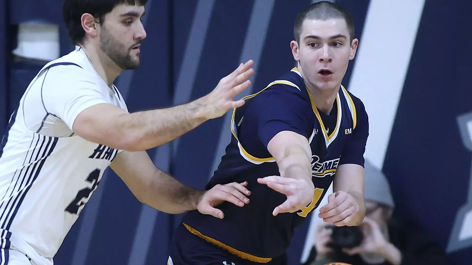 Jack Hall passing the ball, while being defended