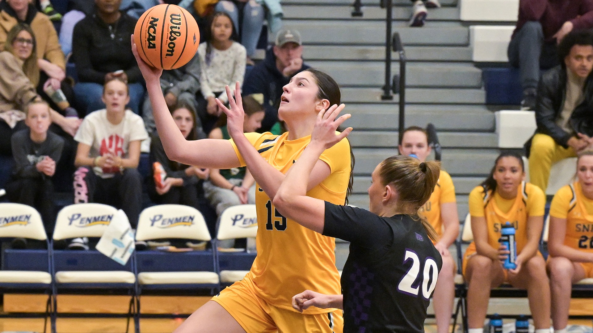 Meghan Gordon driving in for a layup with a defender in the foreground
