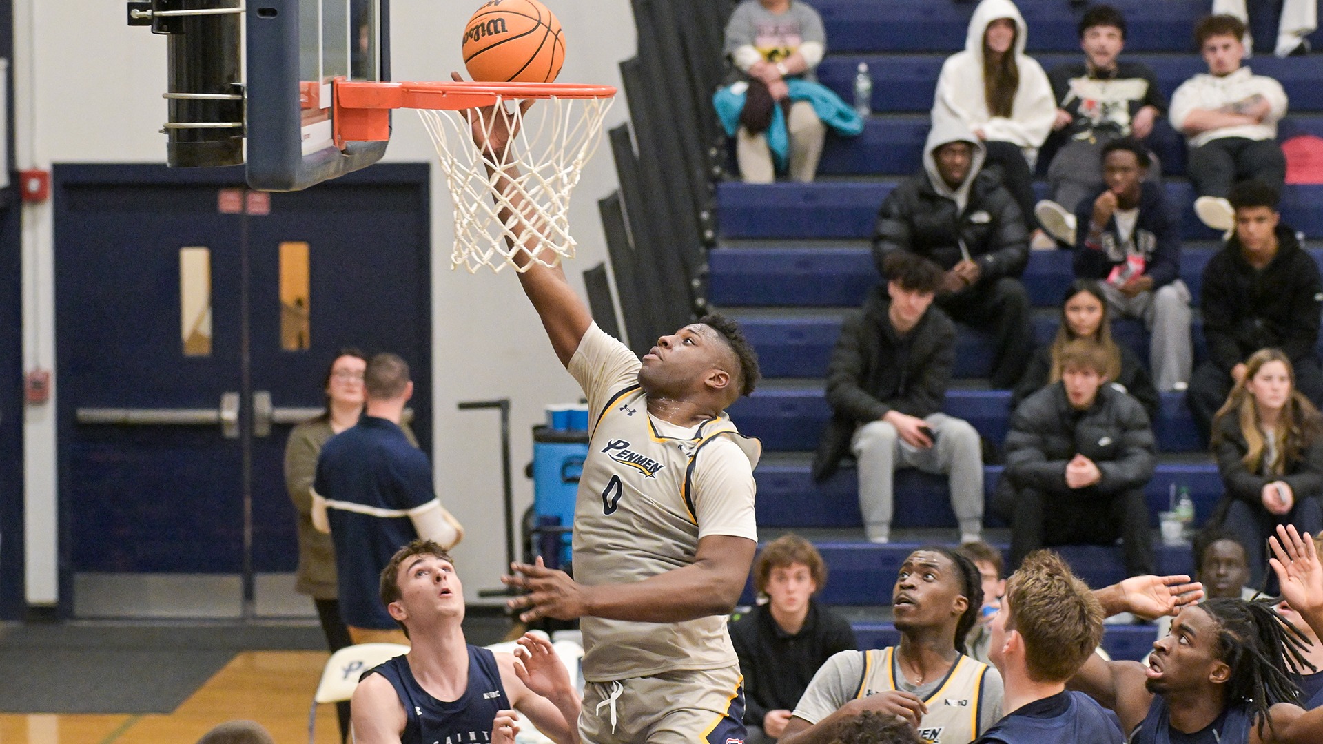 Ugo Nwachukwu dropping in a layup as the other players on the court look on