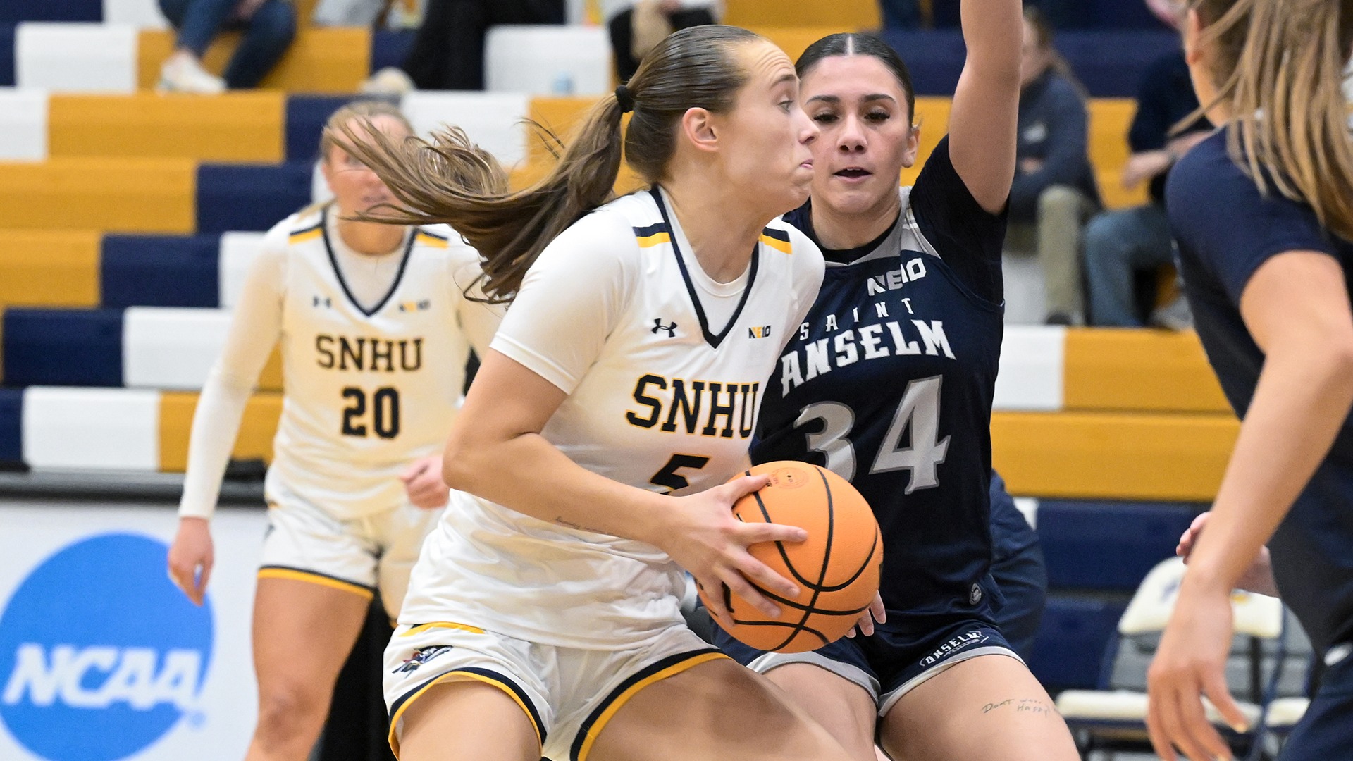 Taylor Brennan driving to the hoop against a defender