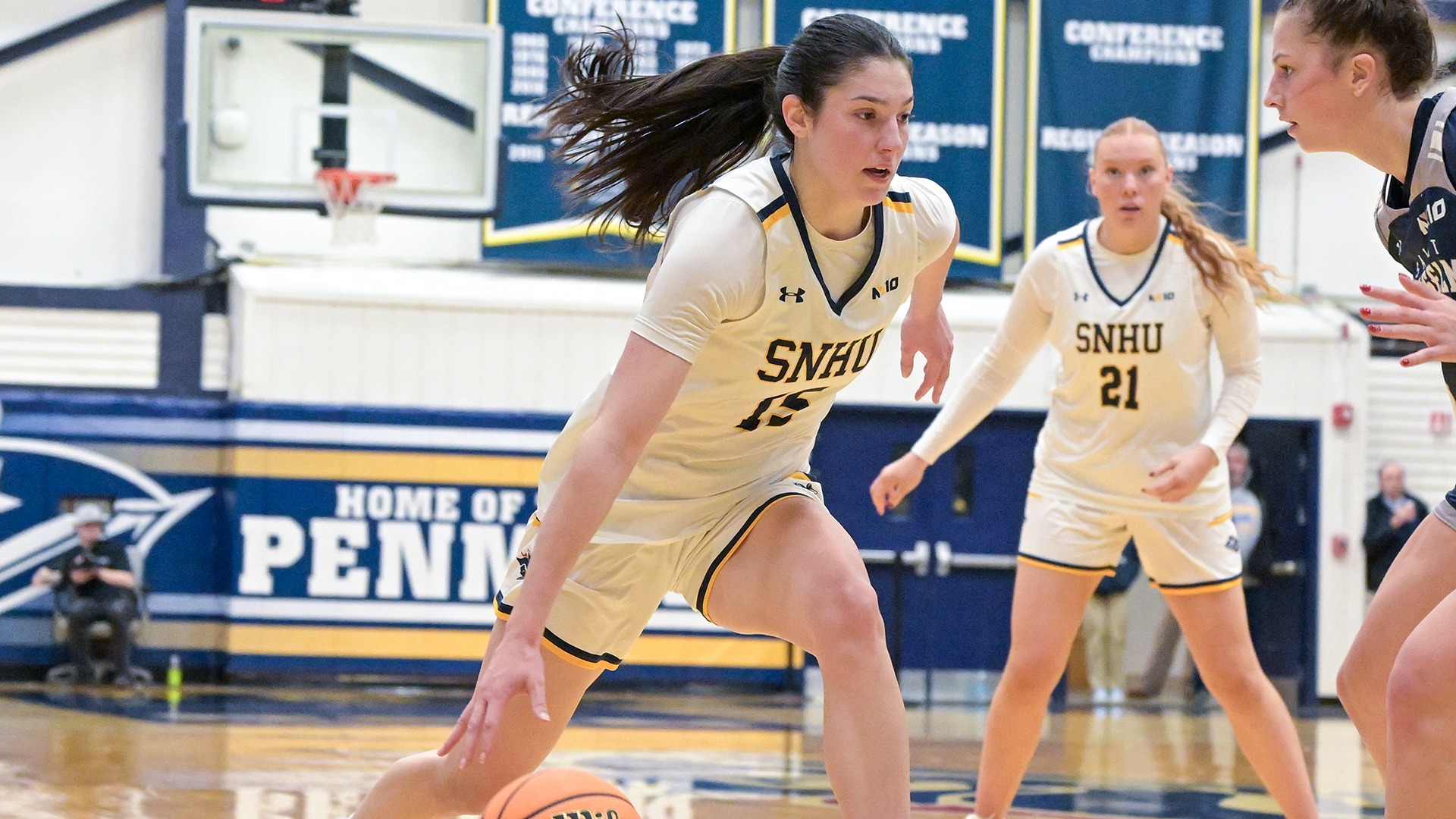 Gordon dribbling while guarded by a defender, with her teammate in the background 