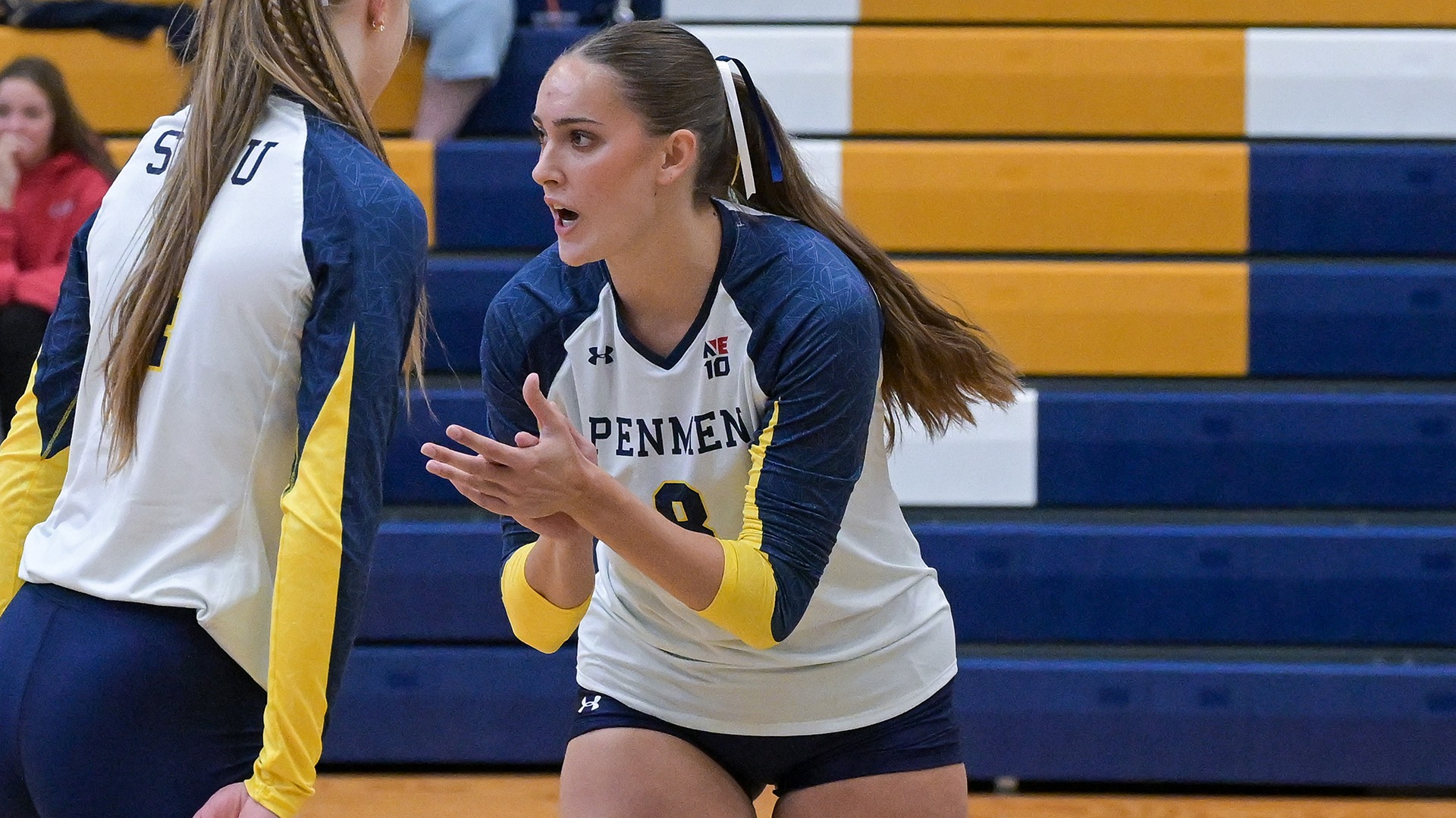 Friebolin clapping prior to a serve, with a teammate next to her