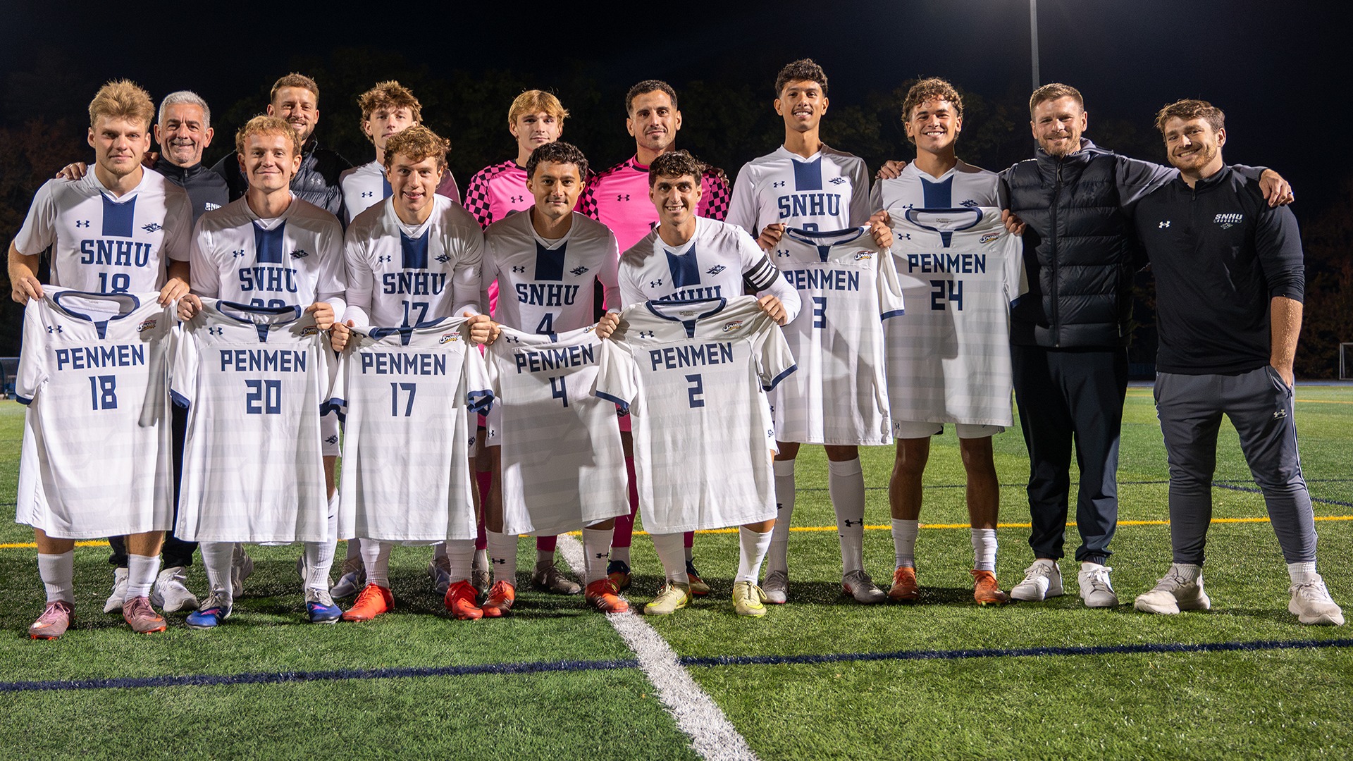 the SNHU men's soccer seniors posing with the coaches, following the 2026 Senior Night ceremony