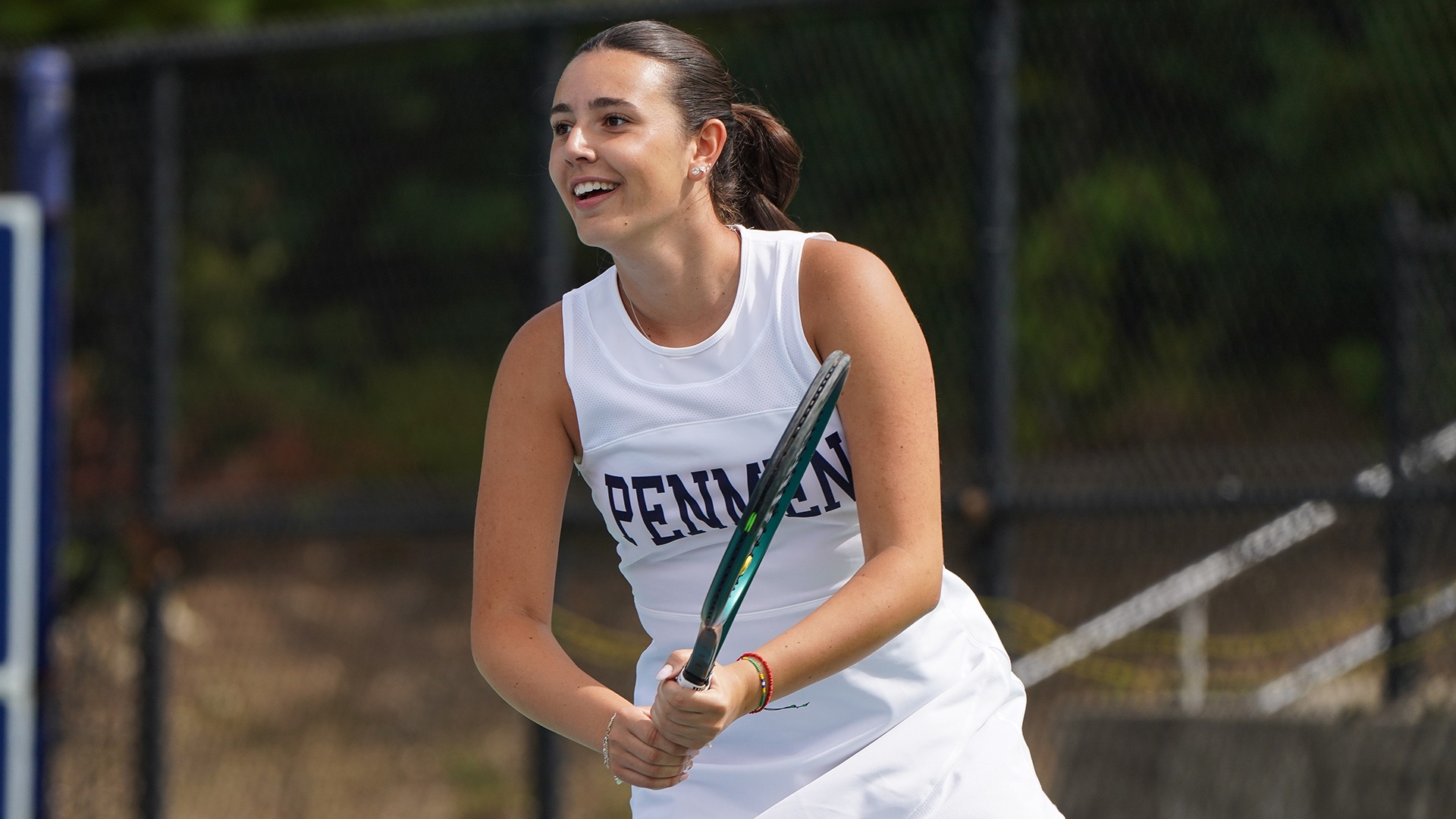 Dajana Abadzic smiling, while holding her racquet with two hands