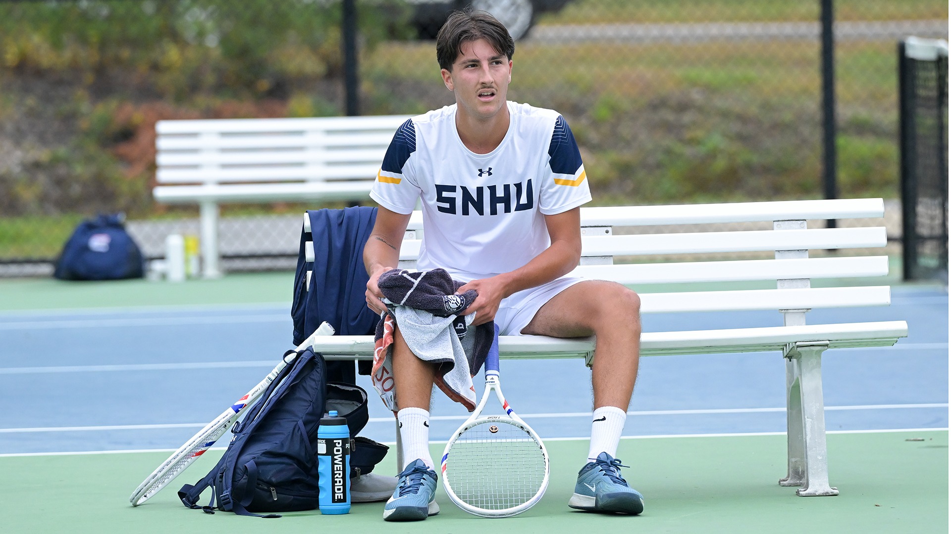 Aurel Creveuil sitting on a bench with his gear in between games
