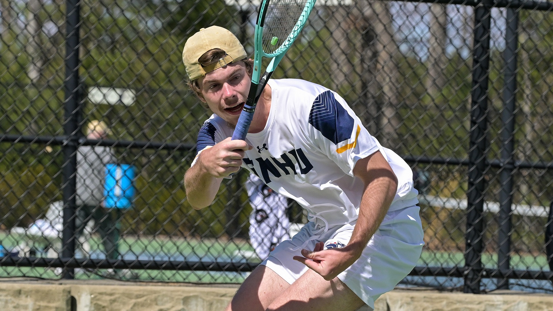 Tristan Chandler watching his lunging forehand shot