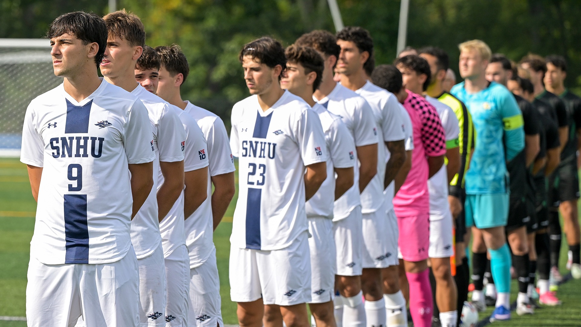 members of the SNHU men's soccer team lined up for the National Anthem