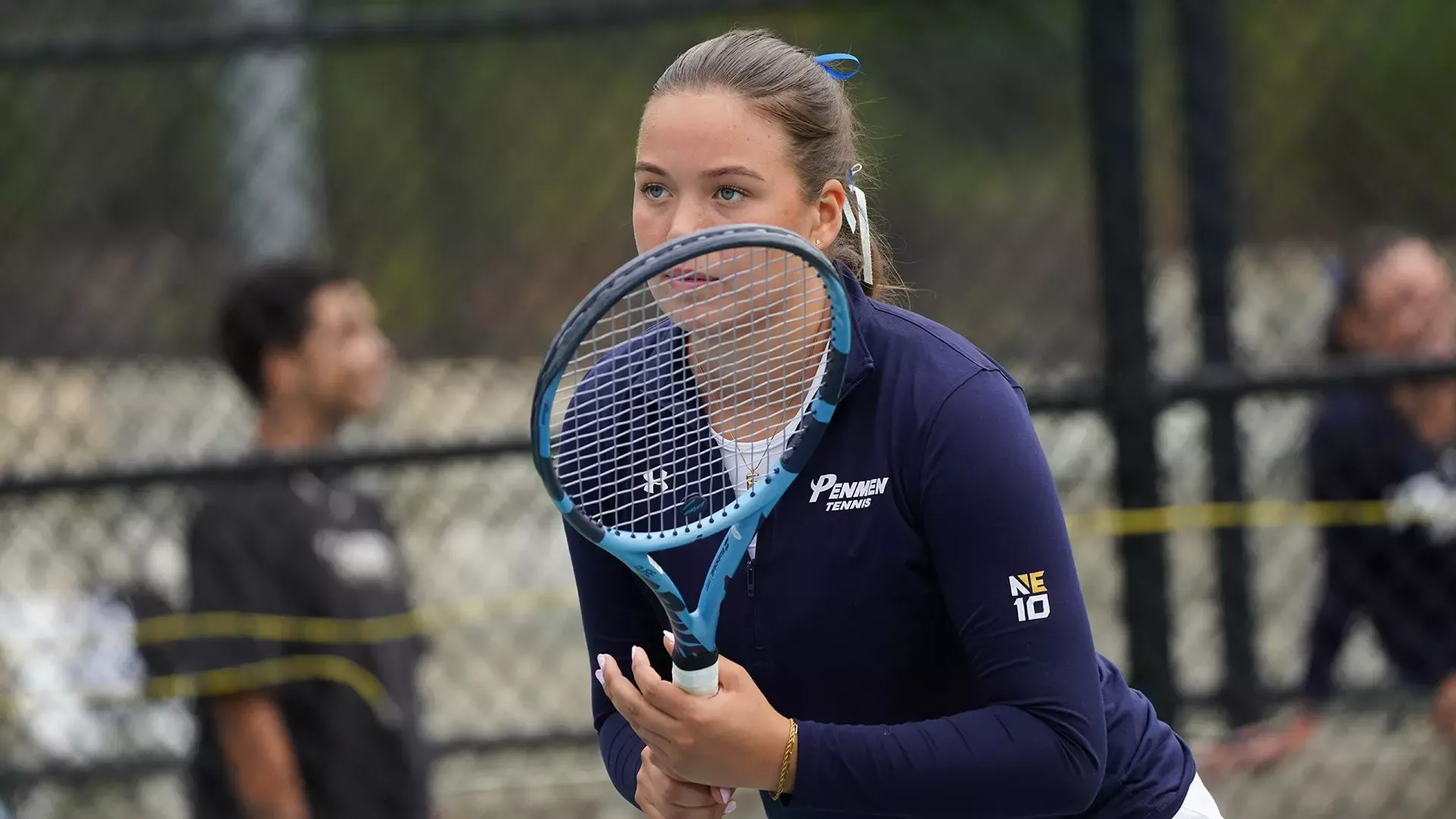 Eylgo Armannsdottir looking through her racquet, while waiting for her opponent's serve