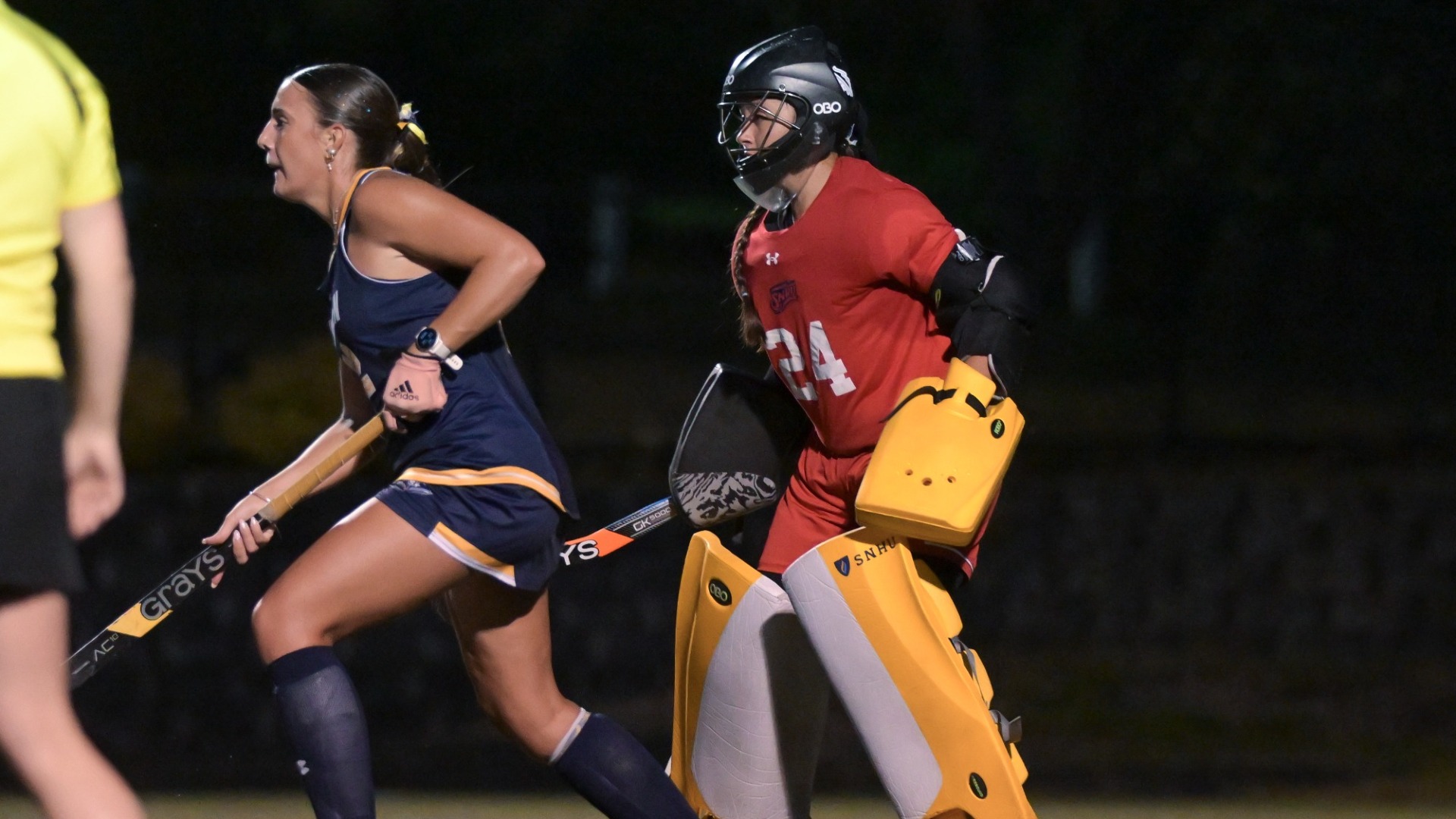 Agustina Miranda Waigand, in red, defends her cage for field hockey