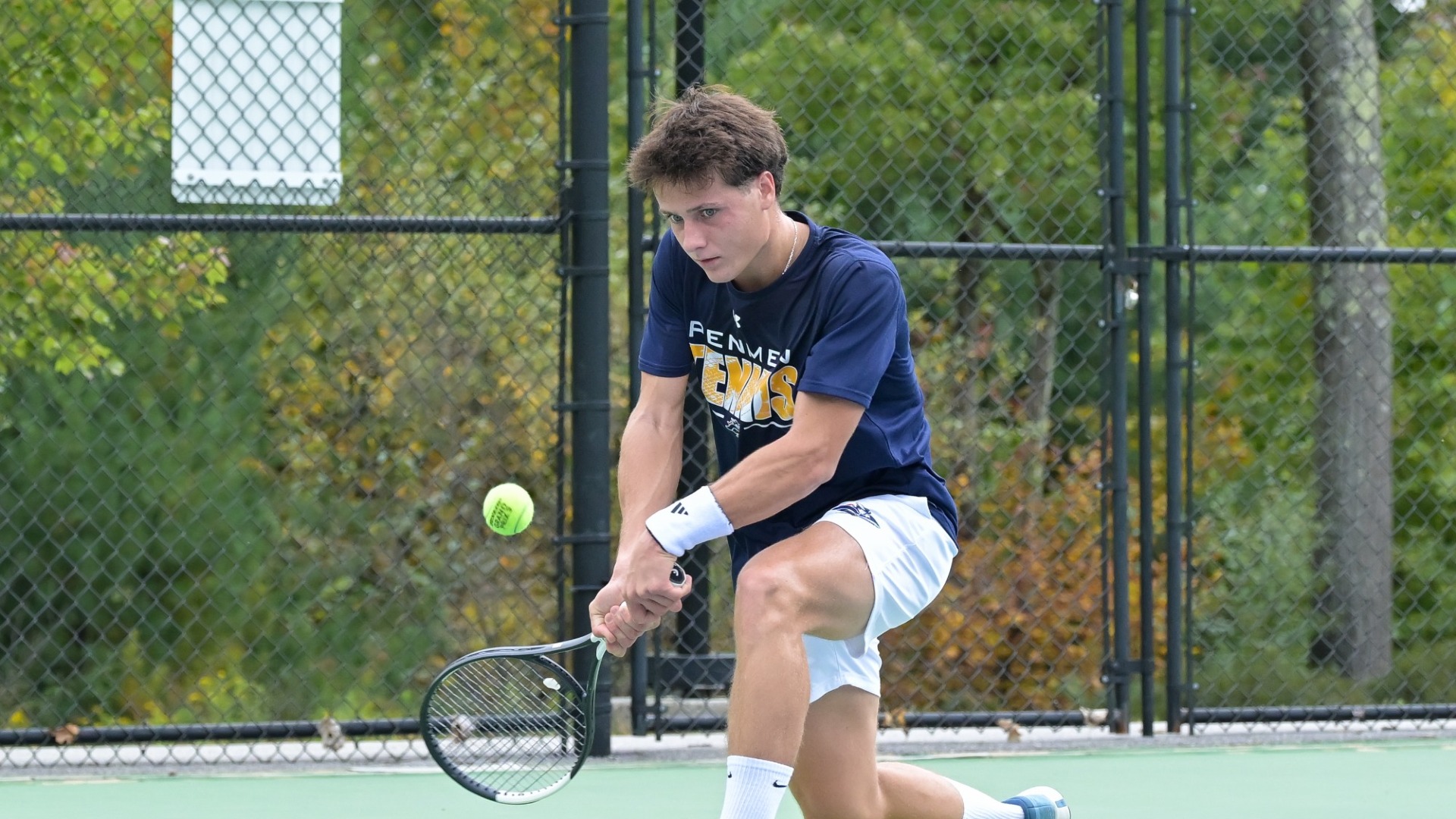 Alexandre Guilcher returning a shot for SNHU men's tennis