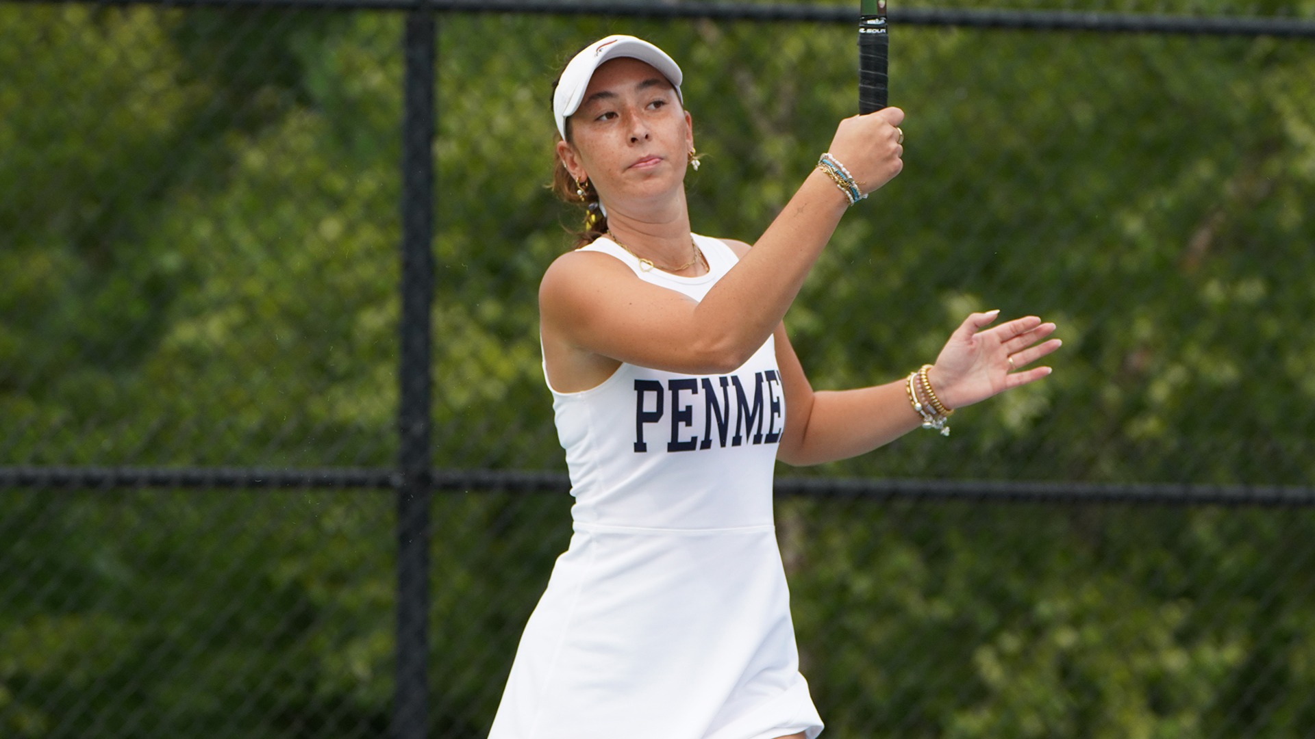Tsui holding her follow through and watching her forehand shot