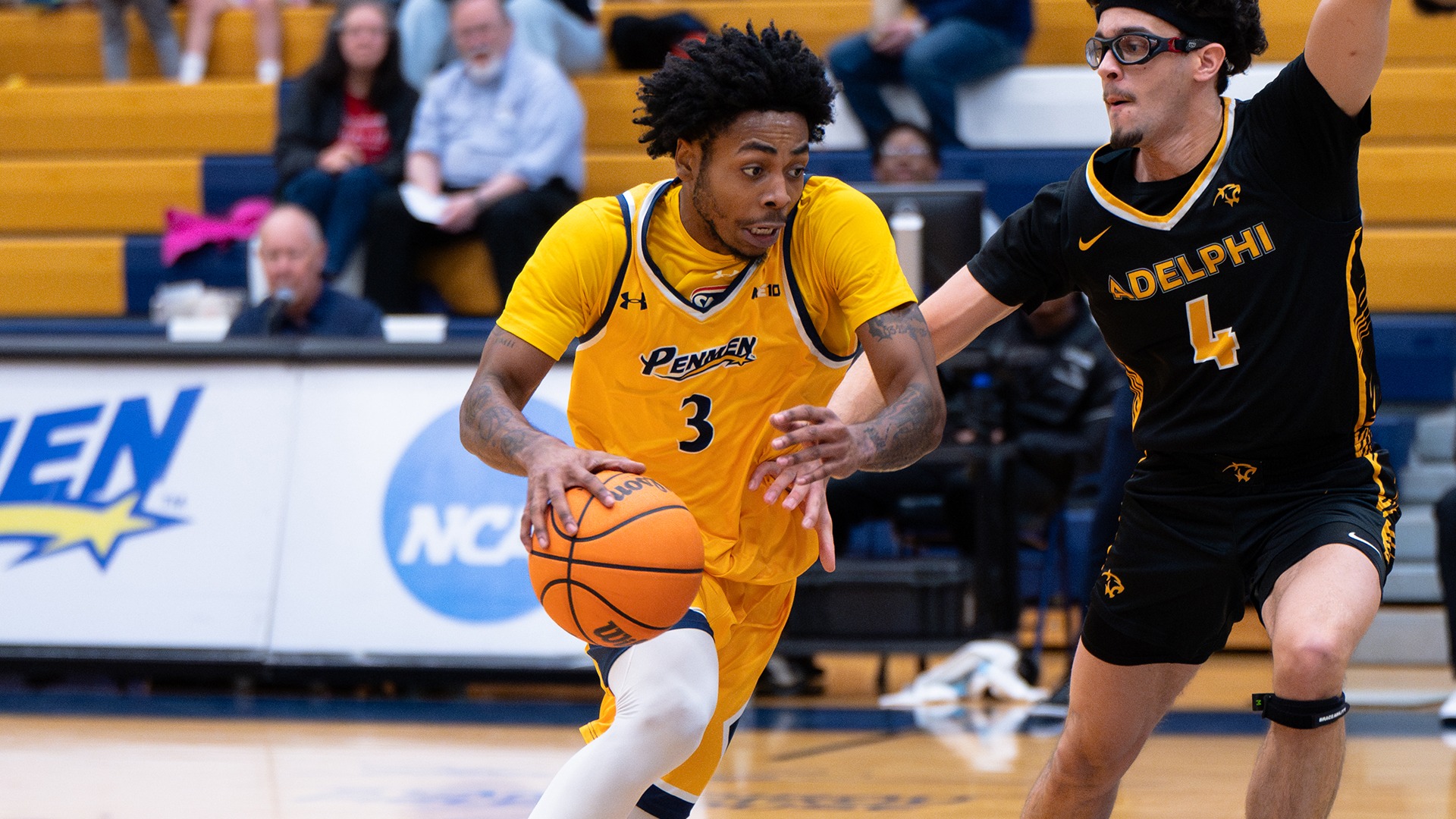 T.J. Morris driving to the hoop while being defended by an opponent