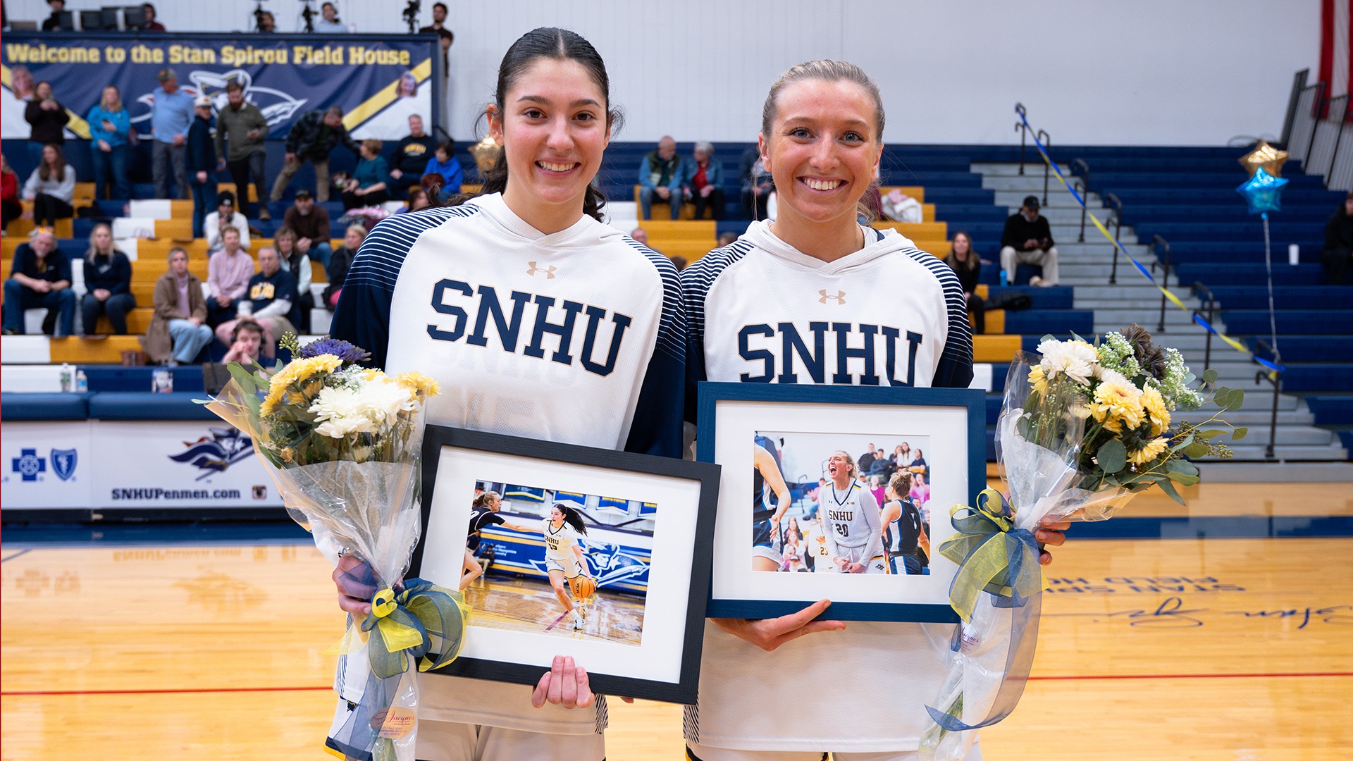 Meghan Gordon and Sydnie DeVries posing following the SNHU women's basketball Senior Day ceremony