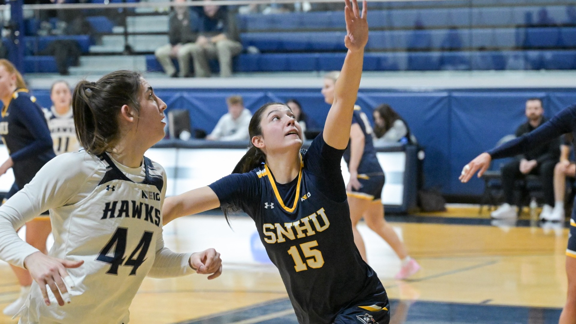 Meghan Gordon of women's basketball has her hand raised to defend in a game against Saint Anselm