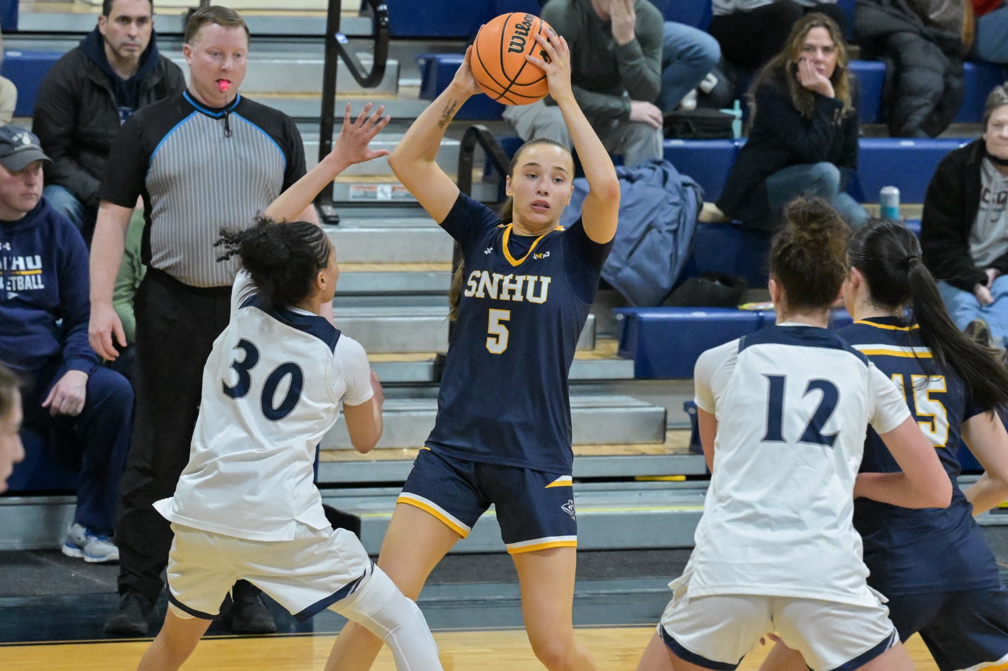Taylor Brennan holds the ball over her head ready to pass