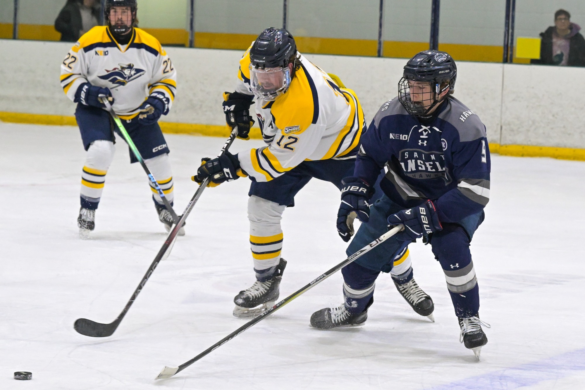 Ryan Pomposelli of Ice hockey works the puck as defender Tootoo Fotheringham looks on